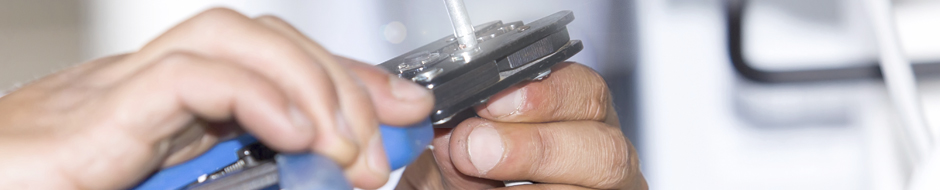 man using blue handled cable cutters